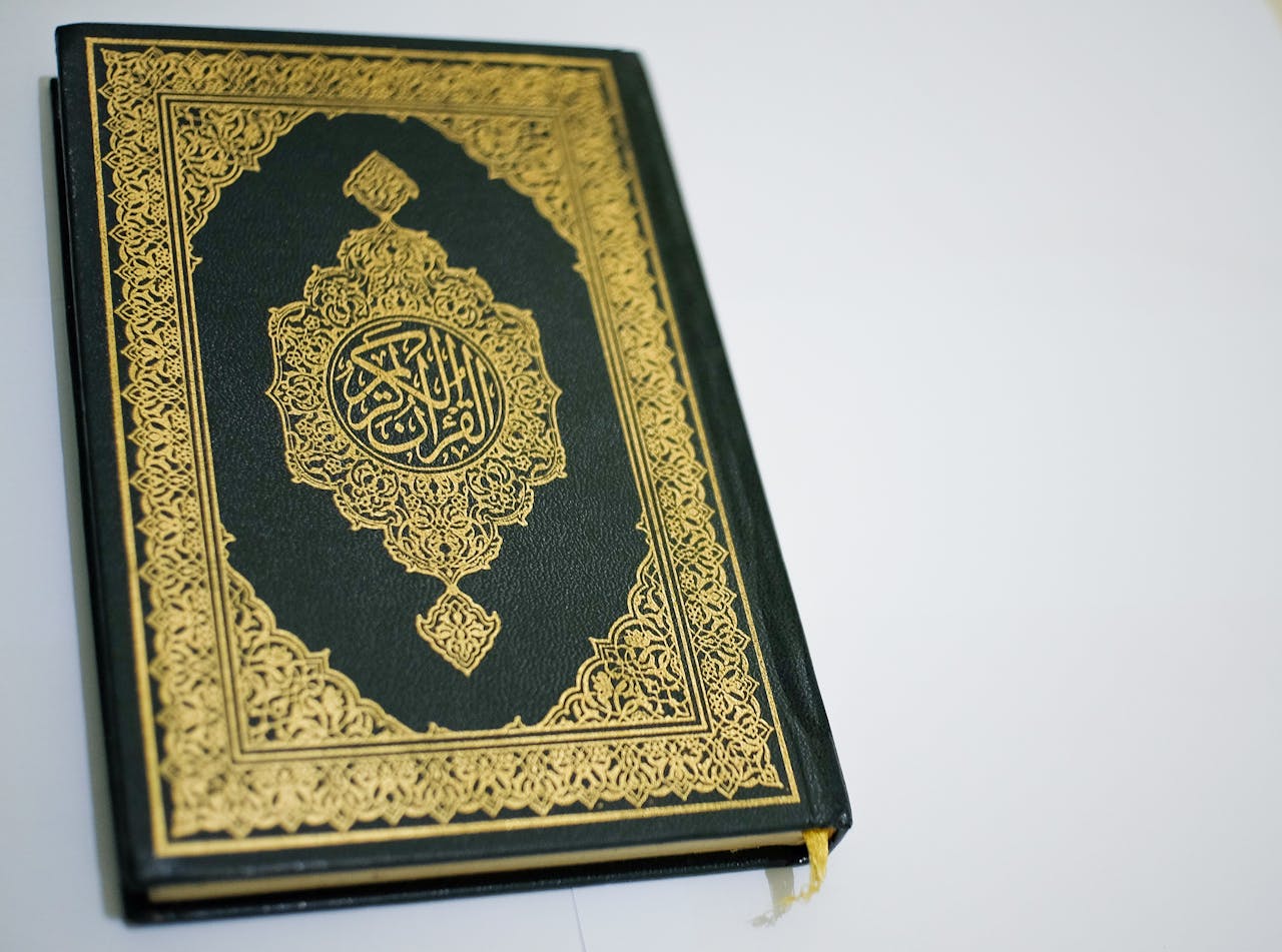 Stunning close-up of the Quran with intricate gold details on the cover, perfect for religious themes.